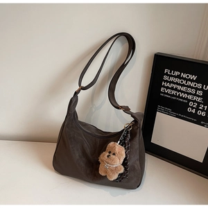 Deep brown suede Hobo bag with adjustable strap and cute plush bear charm detail