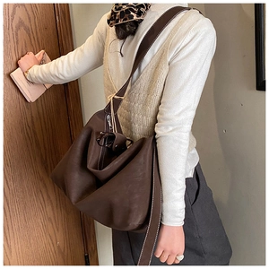 Detail of dark brown Hobo bag featuring vintage stitching and matte textured material