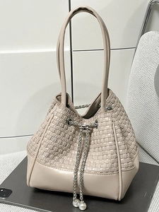 Beige woven bucket bag with pearl drawstring and silver chain for women