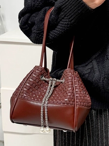Women's burgundy bucket bag with woven texture, silver chain drawstring and pearl details