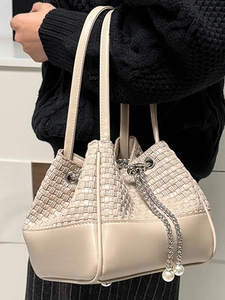 Elegant beige bucket bag with woven texture and pearl chain detail for women
