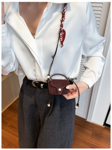 Mini dark brown suede crossbody bag with decorative wooden beads on fine rope strap