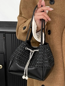 Chic black bucket bag with woven texture and pearl drawstring details for women