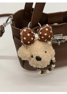 Cute teddy plush puppy bag charm with polka dot bow and beaded strap detail