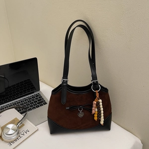 Retro suede tote bag with black leather trim, bow detail, and wooden bead accessories