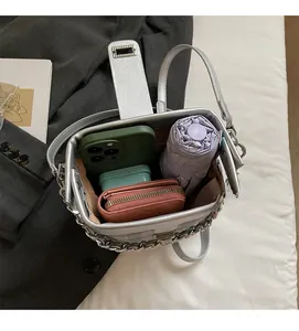 Top view of silver bucket bag interior capacity with metal chain and large space