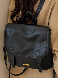 Classic black leather backpack with flap design and gold metal logo for casual commuting