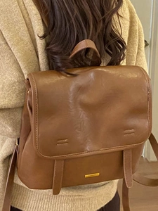 Minimalist brown vintage faux leather backpack for women with flap and gold logo plate