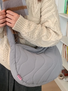 Grey quilted padded crossbody bag with wave pattern stitching for women's daily fashion