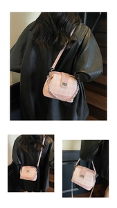 Detail view of pink plaid crossbody bag with metal turn-lock and chunky chain strap