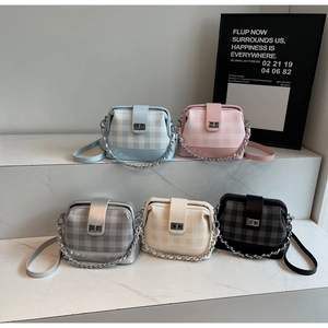 Close-up of minimalist checkered doctor bags in five pastel colors with metal buckles