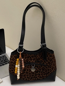 Vintage leopard print shoulder bag with black bow and colorful beaded charm accessories