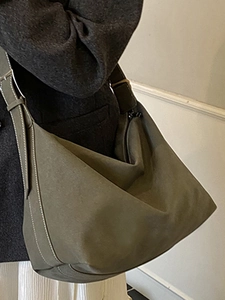 Minimalist pleated hobo bag in olive green with stylish contrast stitching detail