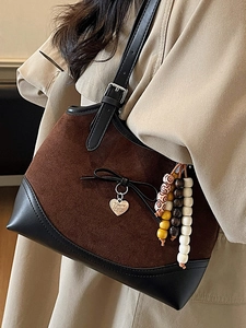 Vintage leopard-inspired suede shoulder bag with heart pendant and beaded detail