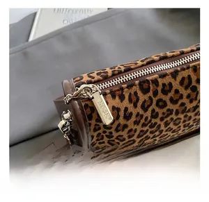 Detailed close-up of leopard print handbag with premium KOSK engraved silver zipper