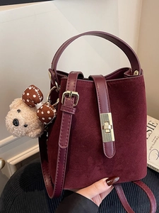 Vintage burgundy suede bucket bag with gold lock and plush bear charm for women