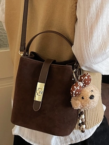 Vintage dark brown suede bucket bag with gold lock and plush bear pendant for women