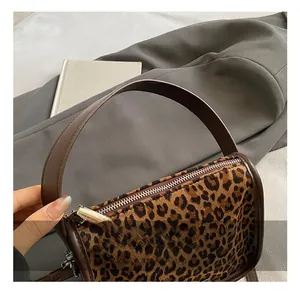 Detailed macro view of leopard print faux fur texture and premium metal zipper detail
