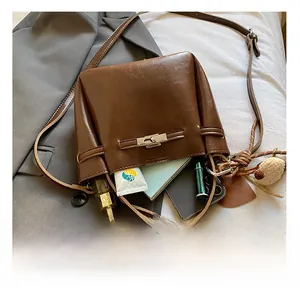 Top view of brown bucket bag interior showing capacity for phone and cosmetics