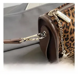 Close-up of leopard print velvet material with silver metal hardware and star pendant