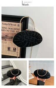 Detailed close-up of leopard print shell clutch with gold chain and round metal handle