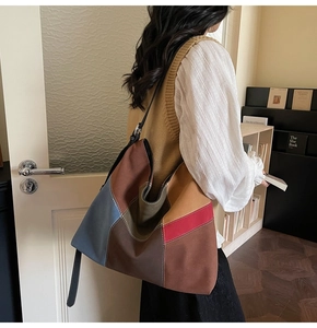 Detail of color-block tote bag with suede texture and adjustable black leather strap