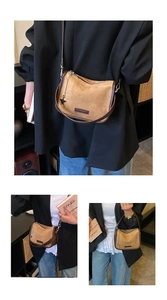 Detail of vintage brown suede crossbody bag with star charm and metallic chain accent