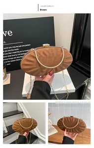 Close-up of brown pleated shell clutch with crystal clasp and golden snake handle