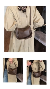 Detail view of dark brown pebbled leather crossbody bag with star pendant and long strap