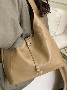 Minimalist caramel brown faux leather tote bag for women showing large capacity and soft texture