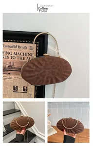 Macro detail of coffee animal print shell clutch with gold handle and chain strap