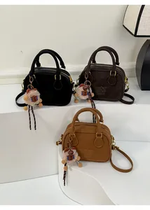 Suede crossbody bags in three colors with embossed logo and plush bear accessory