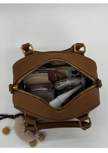 Interior view of brown faux leather bowling bag showing spacious storage for daily items
