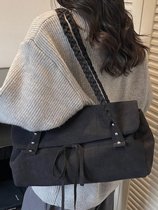 Retro black tote bag with woven shoulder strap and rivet details for women's commuting