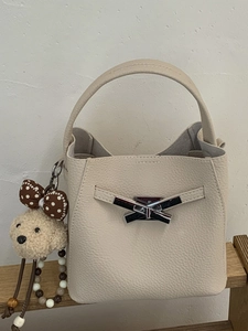Retro beige leather bucket handbag with silver bow detail and plush puppy charm