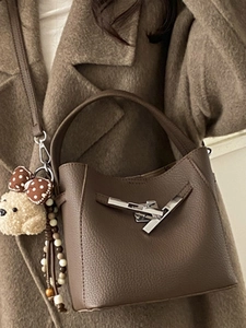 Vintage brown leather bucket bag with silver clasp and plush bear charm for women