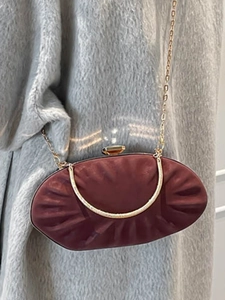 Elegant burgundy pleated clutch bag with gold metal handle and chain shoulder strap