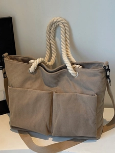 Brown corduroy tote bag with rope handles and large front pockets for winter commuting
