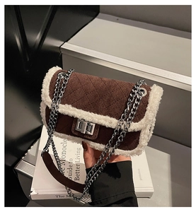 Detail of vintage square bag with brown suede quilting and white faux fur trim