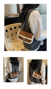 Detail view of brown suede crossbody bag with white faux fur trim and chain strap