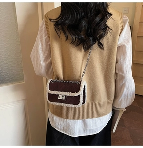 Close-up of brown quilted velvet crossbody bag with white faux fur trim and silver chain