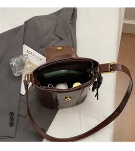 Interior view showing the large capacity and pockets of this vintage oil wax leather bucket bag