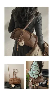 Detail view of retro brown faux leather handbag with decorative pockets and bear charm