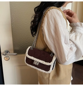 Detail of quilted velvet handbag with faux shearling trim and silver chain strap