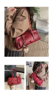 Detail of vintage burgundy bowling bag with zippers and cute teddy bear charm