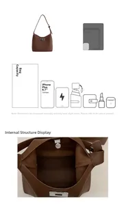 Detail view of the interior capacity and rotating metal lock of this brown leather bucket bag