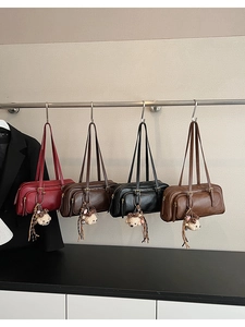 Detail of four vintage bowling bags in burgundy, brown, black and tan with bear charms