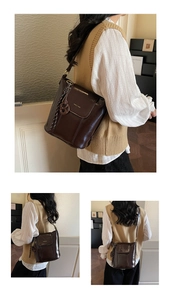 Detail of a dark brown vintage bucket bag with glossy leather texture and gold logo