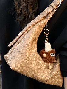 Stylish woven leather tote bag in light brown with cute plush charm for women