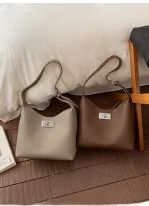 Detailed view of lychee pattern leather bucket bags with iconic metal twist locks